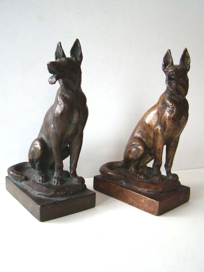 A RARE pair of Paul Herzel (1876-1956) German Shepherd Bookends manufactured by the Pompeian Bronze Company circa 1920